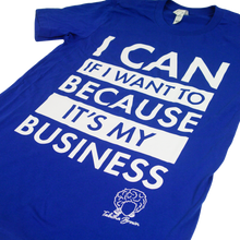 Load image into Gallery viewer, close up angled photo of image of royal blue tee shirt on clear background. full chest print in white that is stacked and reads &quot;i can if i want to because it&#39;s my business&quot; with tabitha brown&#39;s logo of her head with earrings and her name in cursive below on the right.

